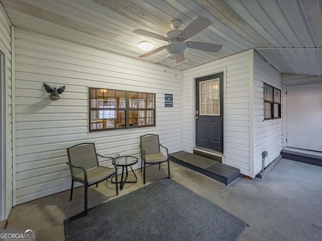 entrance to property featuring a ceiling fan and a patio