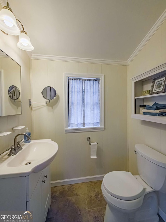 bathroom with toilet, crown molding, and vanity