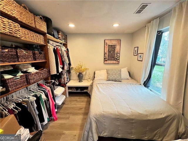 bedroom featuring recessed lighting, visible vents, and wood finished floors