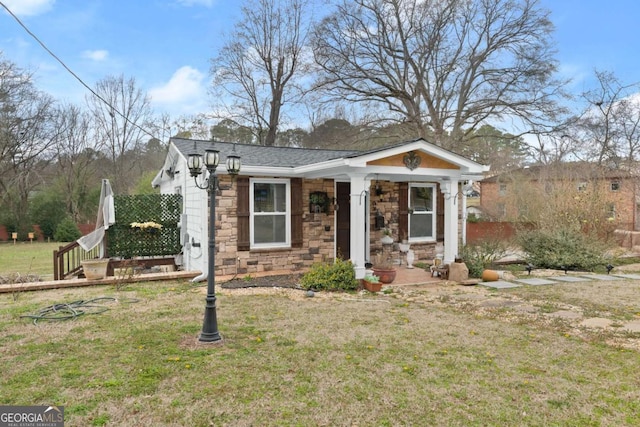 view of front of house with stone siding and a front yard