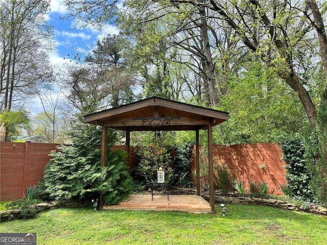 view of yard featuring a fenced backyard, a patio, and a gazebo