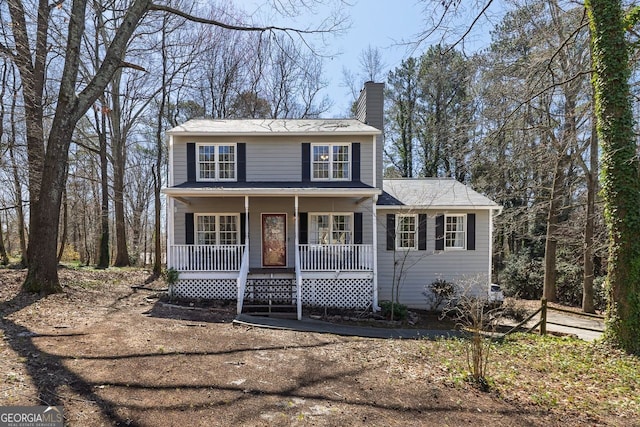 view of front of house featuring covered porch and a chimney