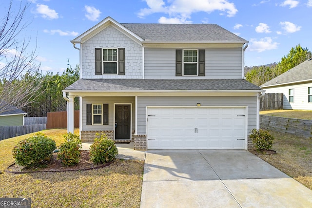 traditional-style home with fence, a garage, driveway, and a shingled roof