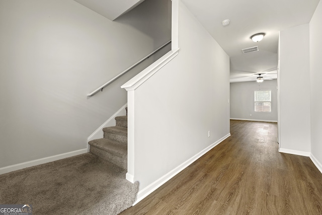 interior space featuring visible vents, a ceiling fan, baseboards, and wood finished floors