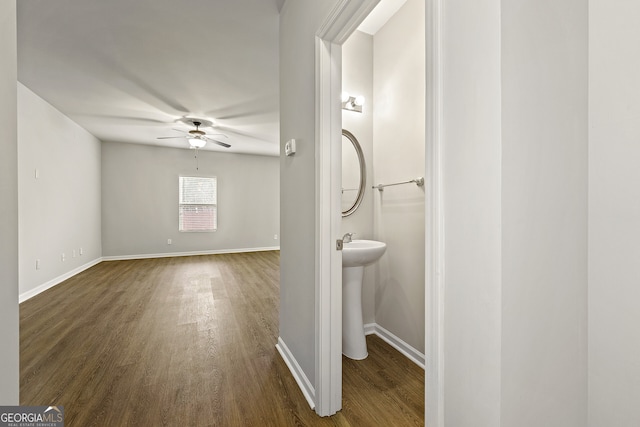 bathroom with baseboards, a ceiling fan, and wood finished floors