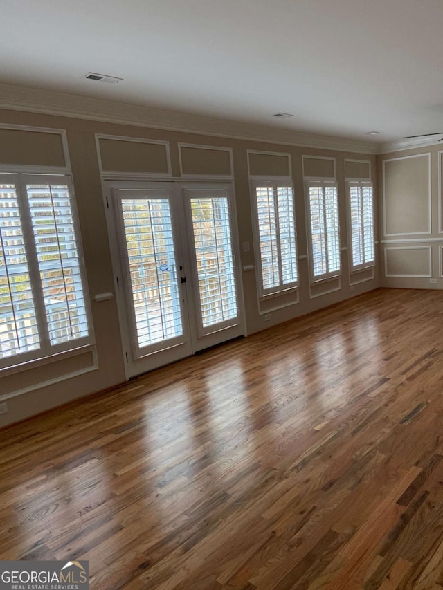 interior space with wood finished floors and a decorative wall