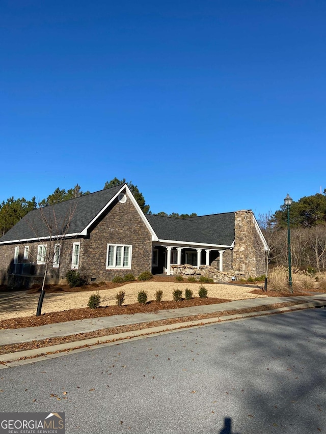 ranch-style house with stone siding