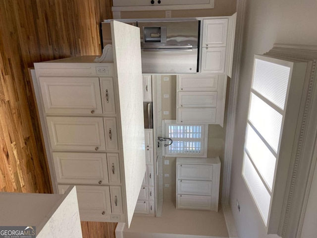 kitchen with light countertops and white cabinets