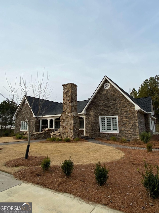 ranch-style home featuring a chimney and a front yard