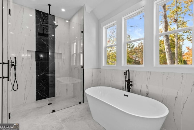 full bathroom with a healthy amount of sunlight, a soaking tub, a marble finish shower, and marble finish floor