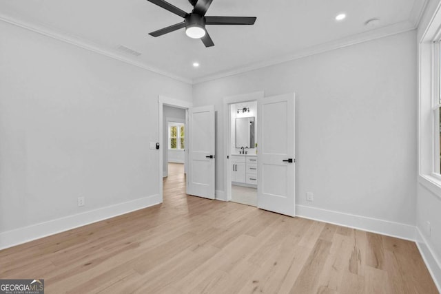 unfurnished bedroom with ornamental molding, light wood-type flooring, visible vents, and baseboards