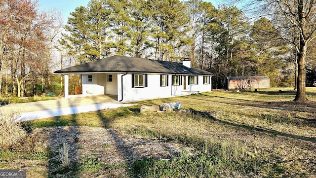 730 Keys Ferry Rd, Jackson, GA 30233 - view of front of property featuring a carport, a storage unit, a chimney, concrete driveway, and a front lawn