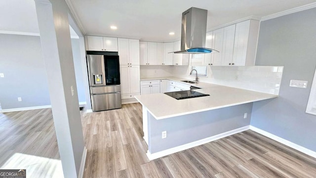 730 Keys Ferry Rd, Jackson, GA 30233 - kitchen with stainless steel refrigerator with ice dispenser, range hood, ornamental molding, decorative backsplash, and a peninsula