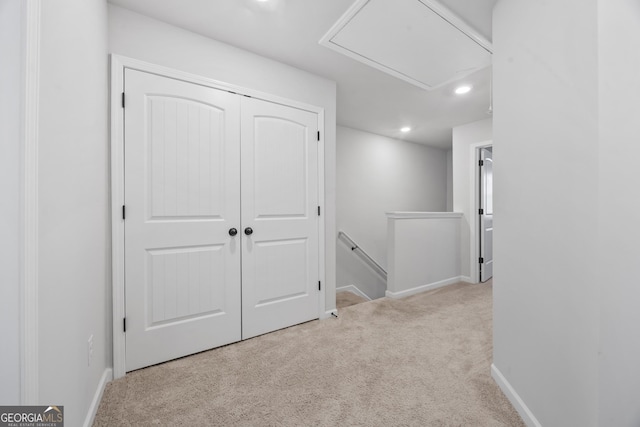 hallway featuring carpet floors, recessed lighting, an upstairs landing, and baseboards