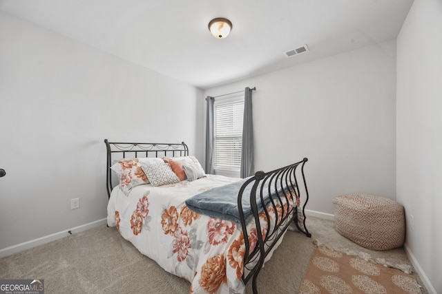 carpeted bedroom featuring visible vents and baseboards