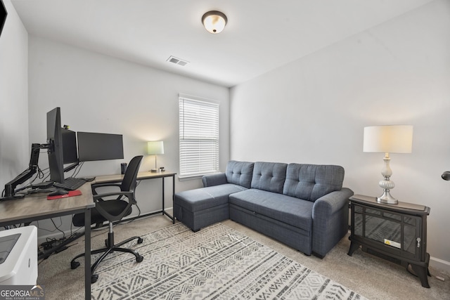 office area featuring baseboards, visible vents, and carpet flooring