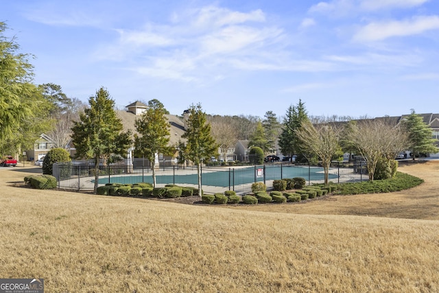 pool featuring fence and a lawn