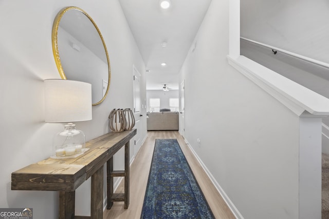 hallway with recessed lighting, wood finished floors, and baseboards