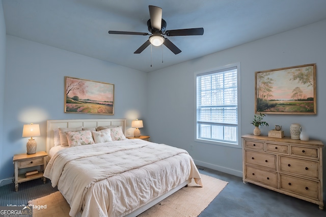 bedroom with baseboards, dark carpet, and ceiling fan