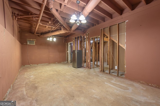 below grade area featuring water heater and a wall mounted air conditioner