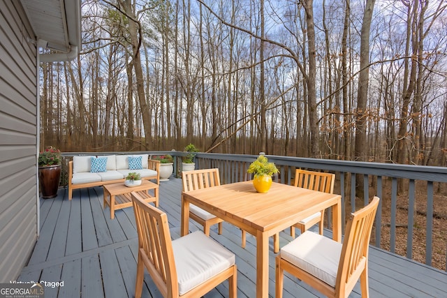 wooden deck with outdoor dining space and an outdoor living space