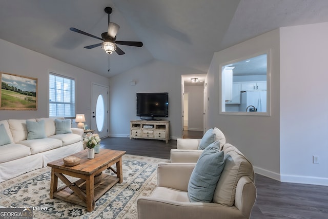 living room with vaulted ceiling, ceiling fan, wood finished floors, and baseboards