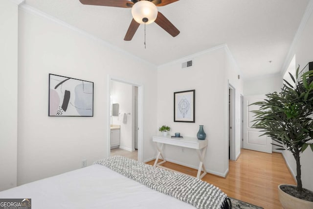 bedroom featuring visible vents, ornamental molding, connected bathroom, light wood-type flooring, and baseboards