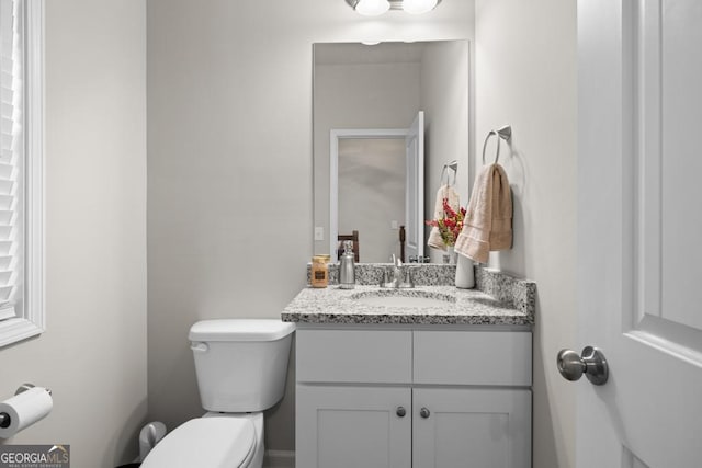 bathroom featuring toilet and vanity