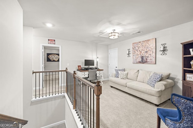 living room with carpet floors, baseboards, and visible vents