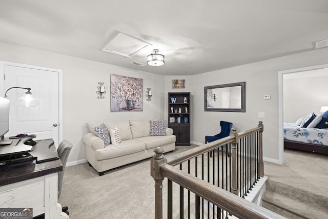 carpeted living area with visible vents, attic access, and baseboards