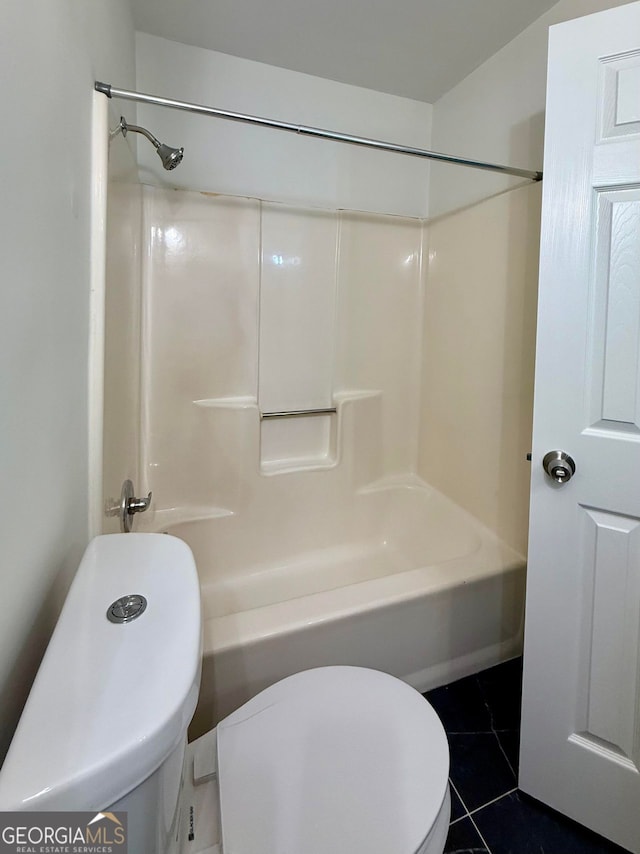 bathroom featuring bathtub / shower combination, toilet, and tile patterned floors