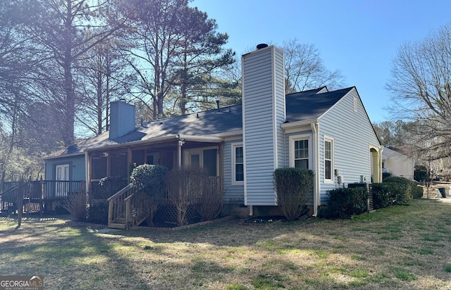 view of property exterior with a yard and a chimney