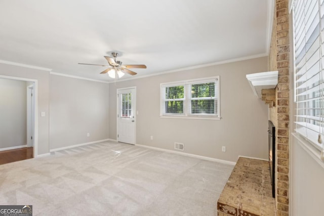 unfurnished living room with carpet, a fireplace, baseboards, and crown molding