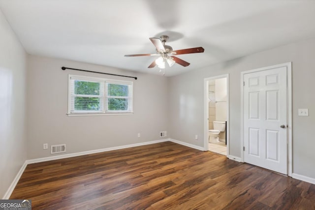 unfurnished bedroom with visible vents, baseboards, and wood finished floors