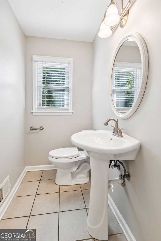 bathroom featuring tile patterned flooring, visible vents, and toilet