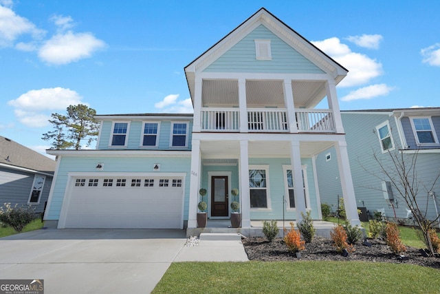 view of front facade featuring covered porch, driveway, a balcony, and a garage