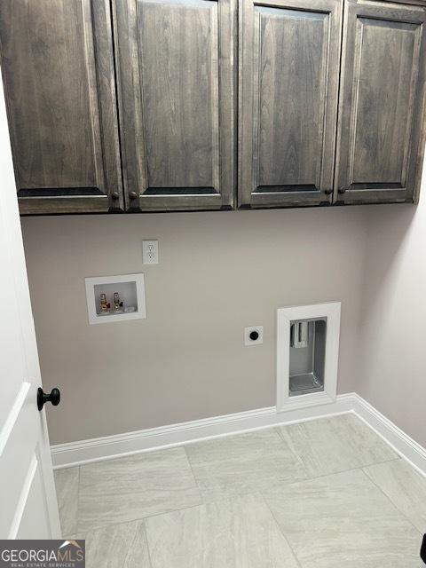 laundry room with washer hookup, cabinet space, hookup for an electric dryer, and baseboards