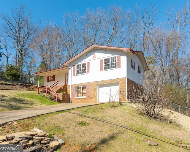 view of front of property with driveway, stucco siding, a front lawn, and brick siding