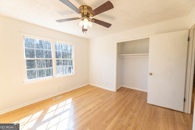 unfurnished bedroom with light wood-style floors, a closet, visible vents, and baseboards