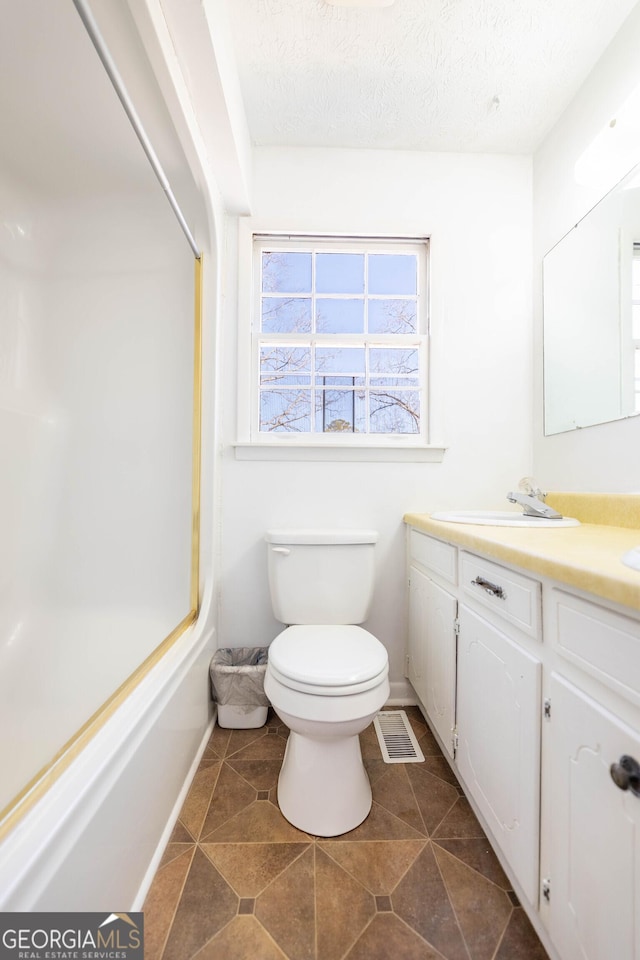 full bathroom with visible vents, a textured ceiling, toilet, and vanity