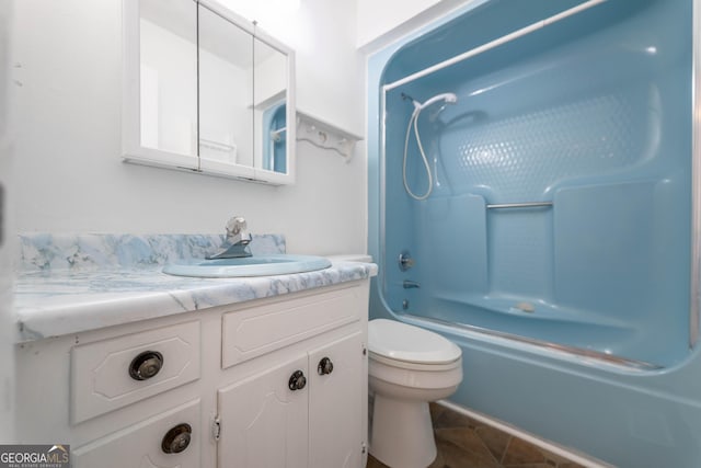 bathroom featuring toilet, tile patterned floors, shower / washtub combination, and vanity