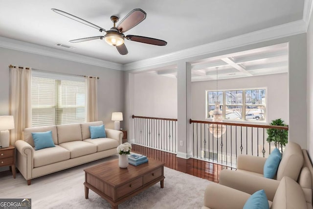 living area with beam ceiling, visible vents, ornamental molding, wood finished floors, and coffered ceiling