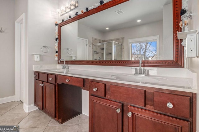 bathroom featuring visible vents, a sink, a shower stall, and tile patterned floors