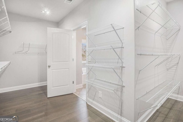 spacious closet with wood finished floors and visible vents