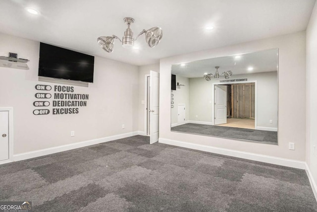 spare room featuring recessed lighting, baseboards, and an inviting chandelier