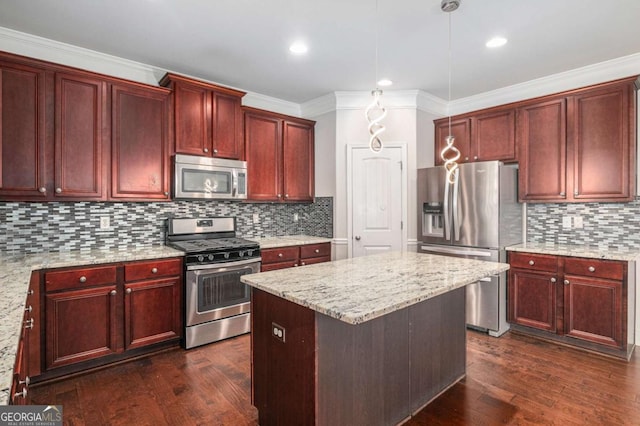 kitchen featuring stainless steel appliances, reddish brown cabinets, dark wood-type flooring, and a kitchen island