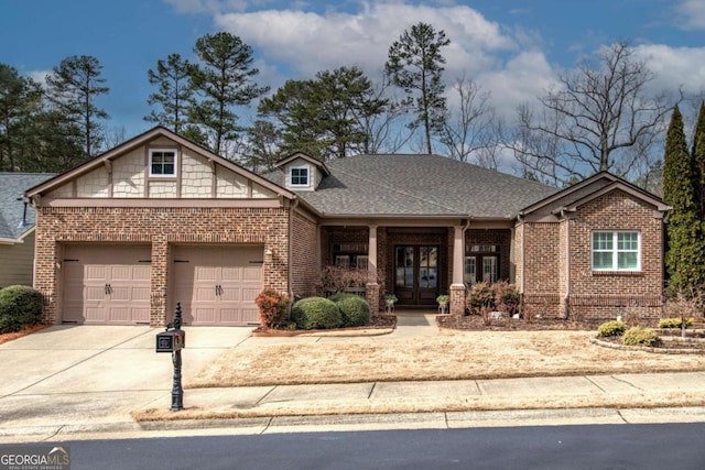 view of front of property featuring a shingled roof, brick siding, driveway, and an attached garage