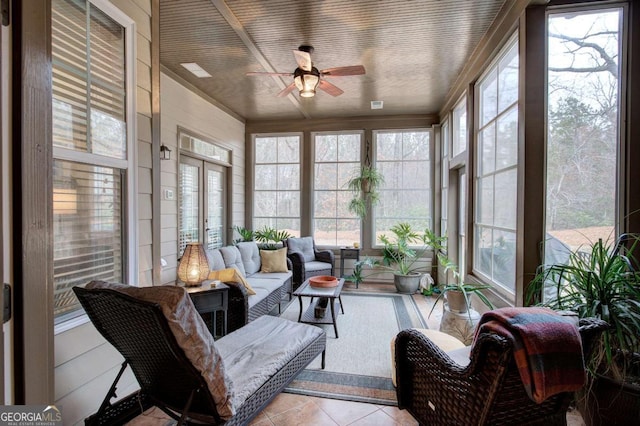 sunroom featuring ceiling fan