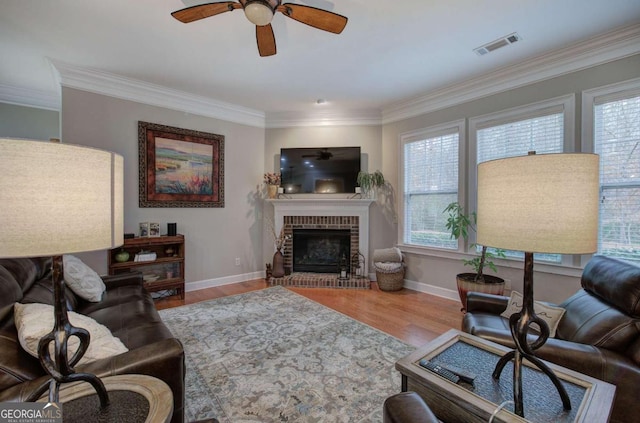 living area featuring plenty of natural light, visible vents, and wood finished floors