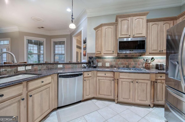 kitchen with a sink, appliances with stainless steel finishes, backsplash, light brown cabinetry, and dark stone countertops